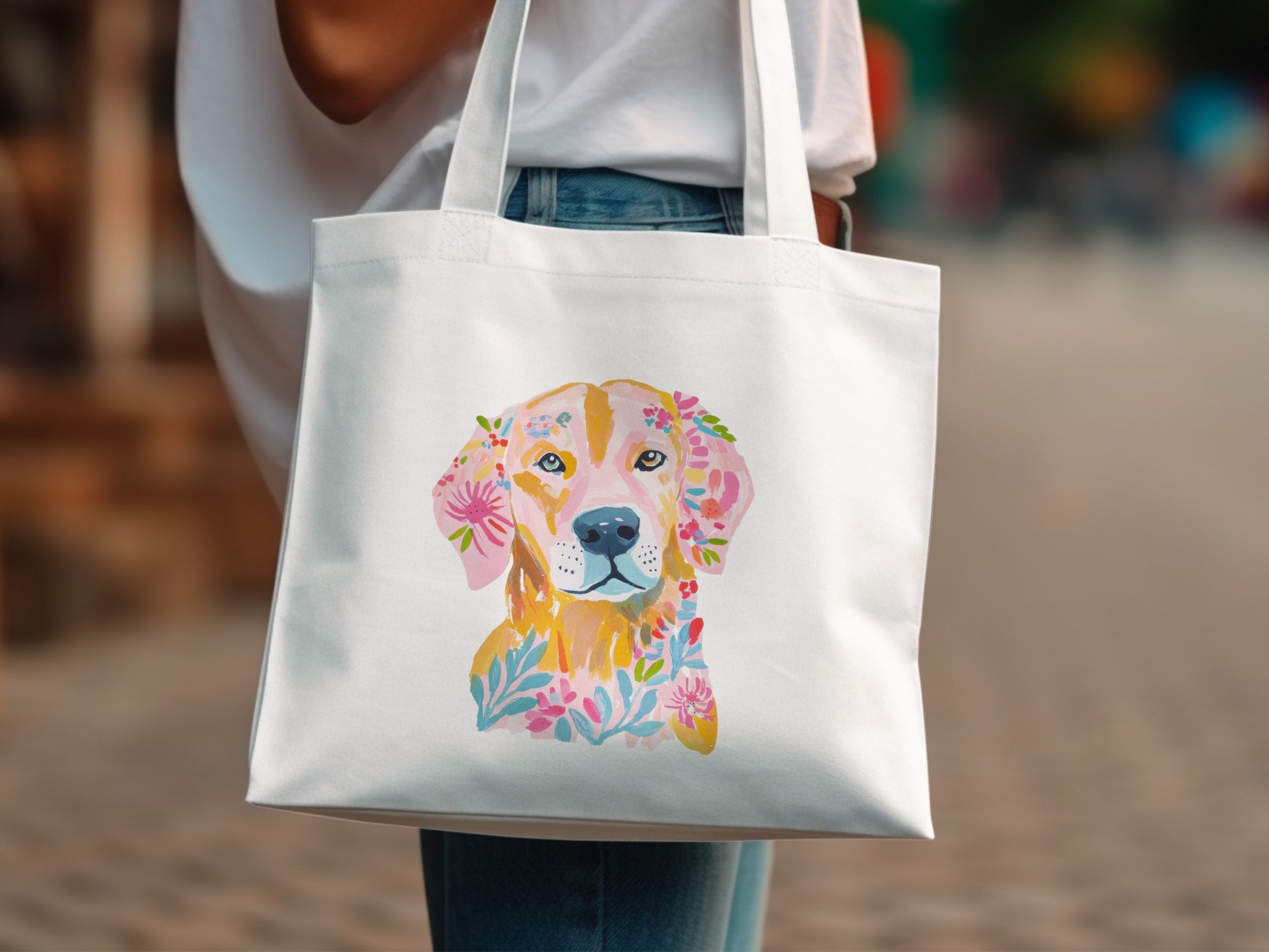 White tote bag with a watercolor golden retriever adorned with flowers.
