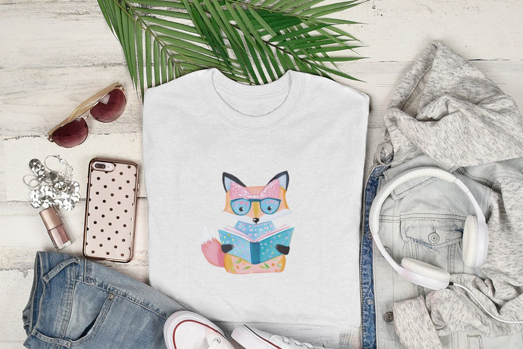 White t-shirt with a cartoon fox wearing glasses reading a book.