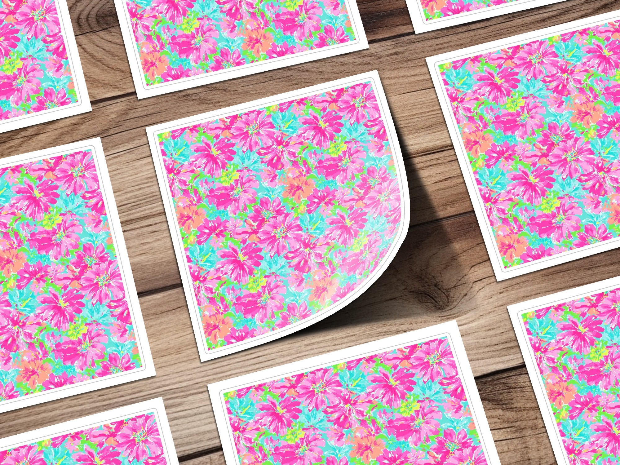 Floral pattern on square cards scattered on a wooden surface.