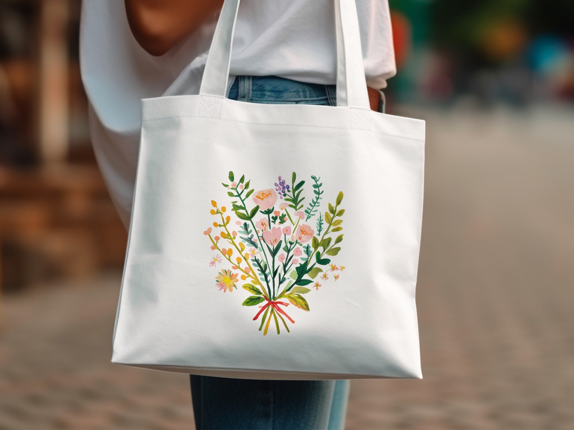 White tote bag with a watercolor bouquet of wildflowers and greenery.