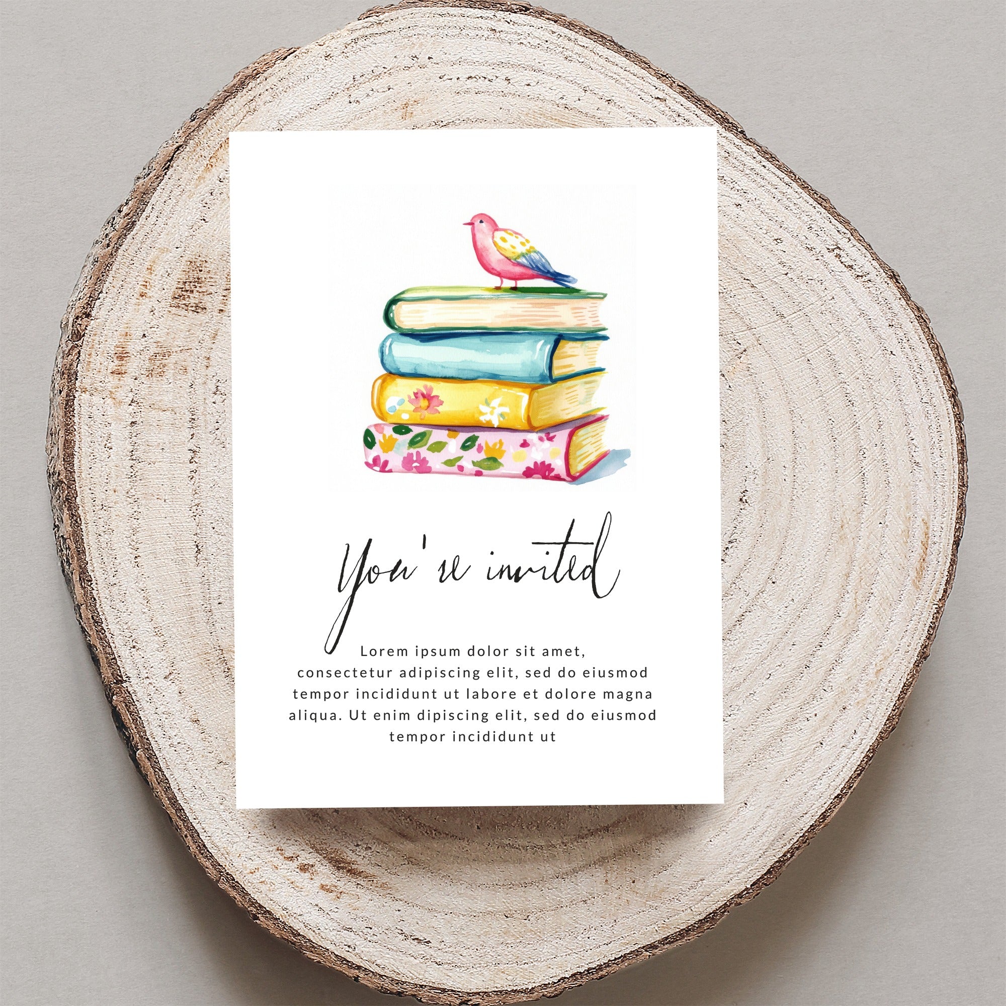 Invitation card with stack of colorful books and bird, "You're invited" text.