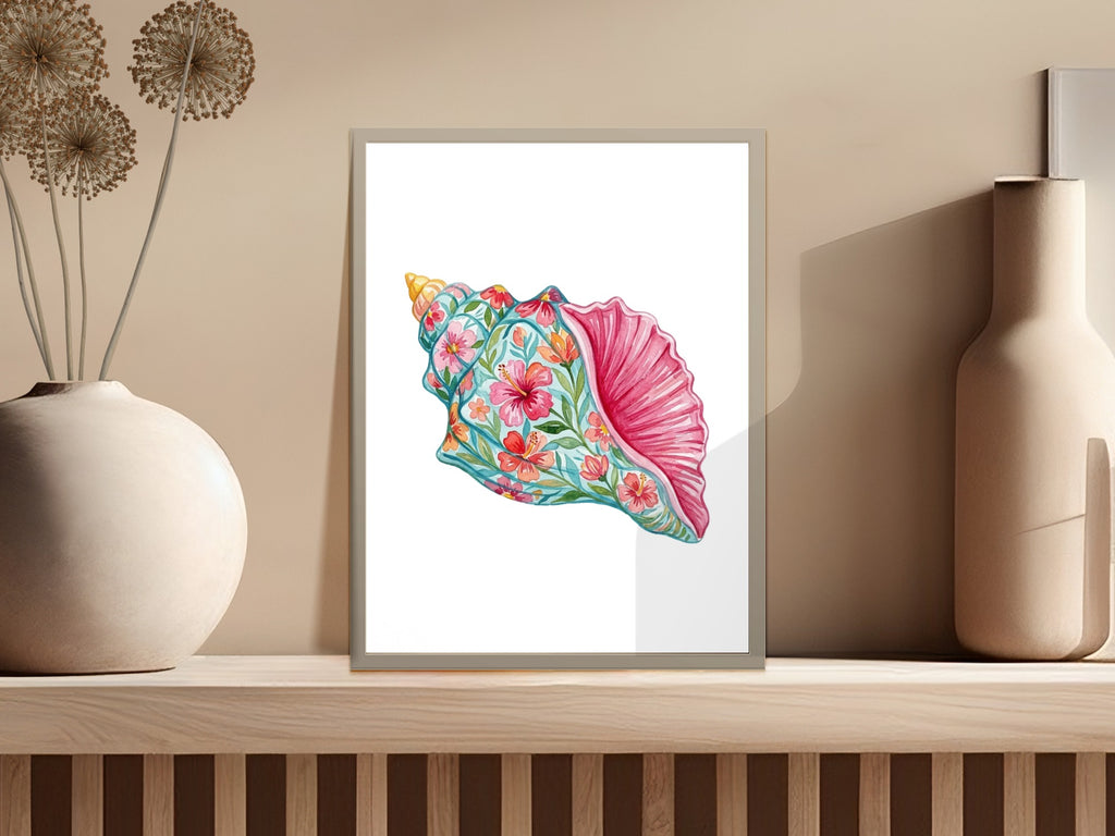 Watercolor illustration of a conch shell with floral patterns in a frame.