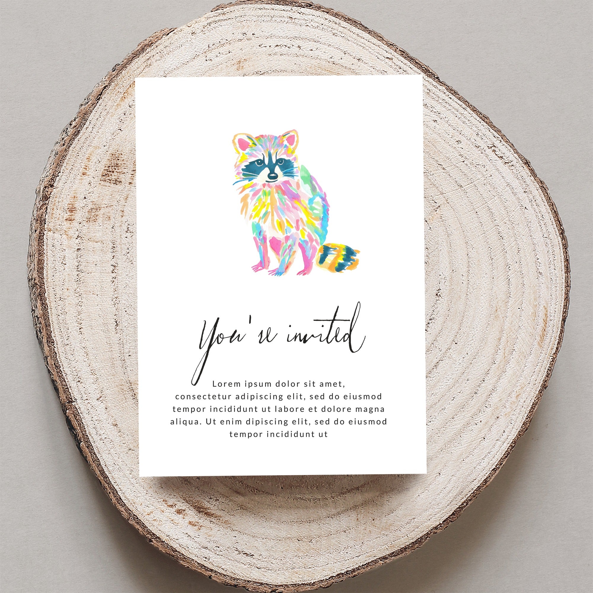 Greeting card with colorful watercolor raccoon and "You're invited" text.