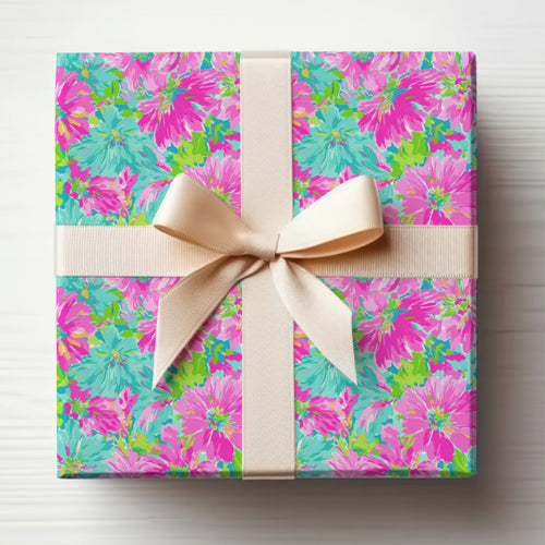 Gift-wrapped box with floral pattern and beige ribbon tied in a bow.