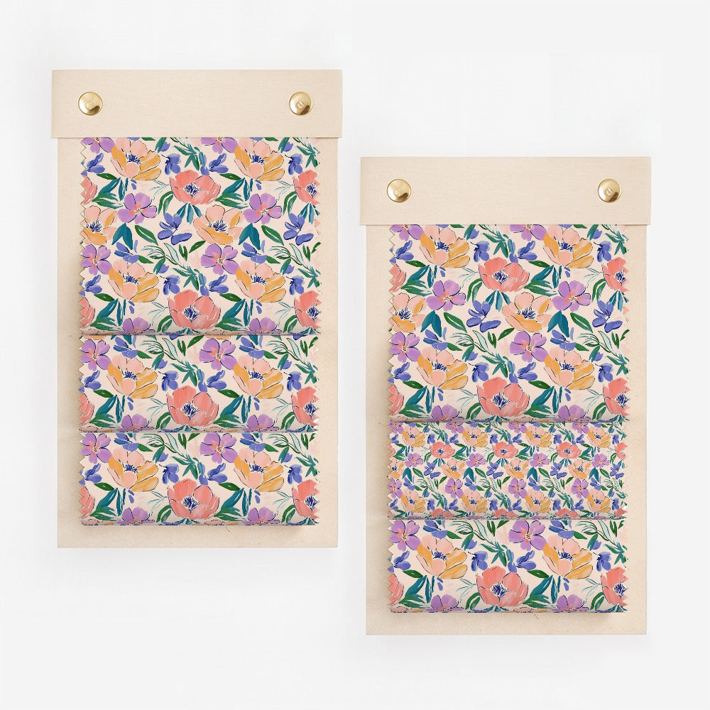 Two fabric swatches with floral watercolor pattern in purple, pink, and orange.