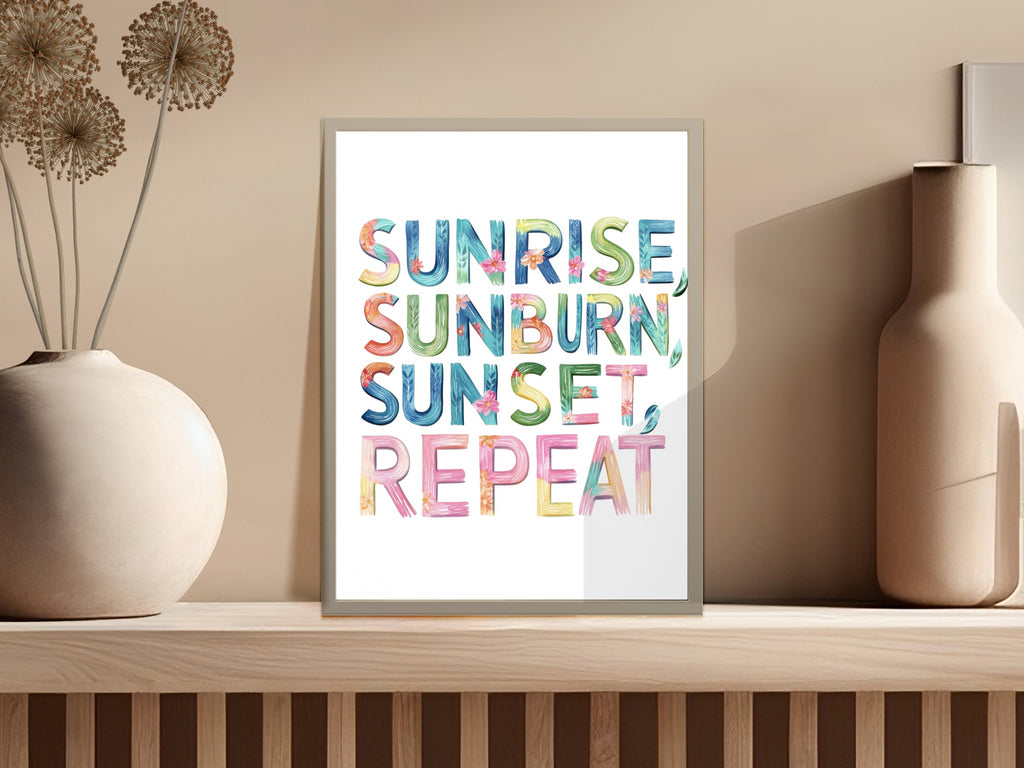 Sunrise, sunburn, repeat in colorful watercolor text on framed art.