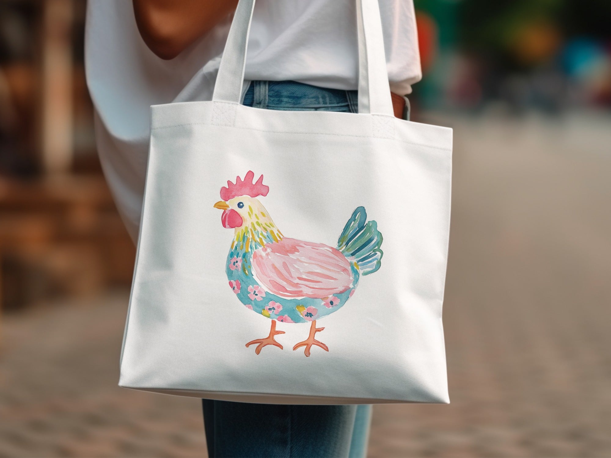 White canvas tote bag with a colorful watercolor chicken design.