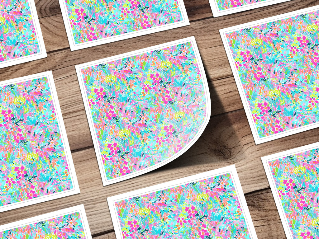 Floral pattern cards spread on a wooden surface, one card is bent.