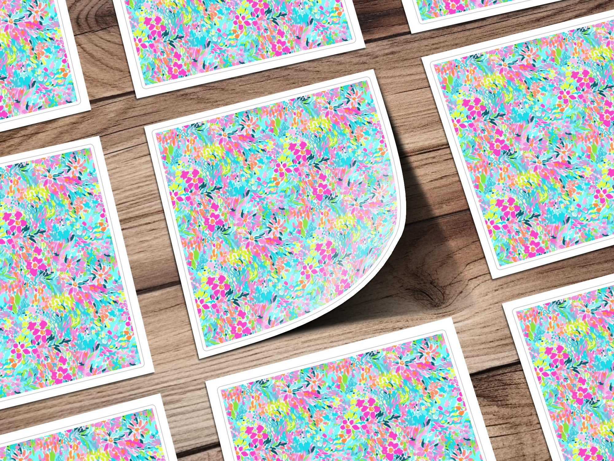 Floral pattern cards spread on a wooden surface, one card is bent.
