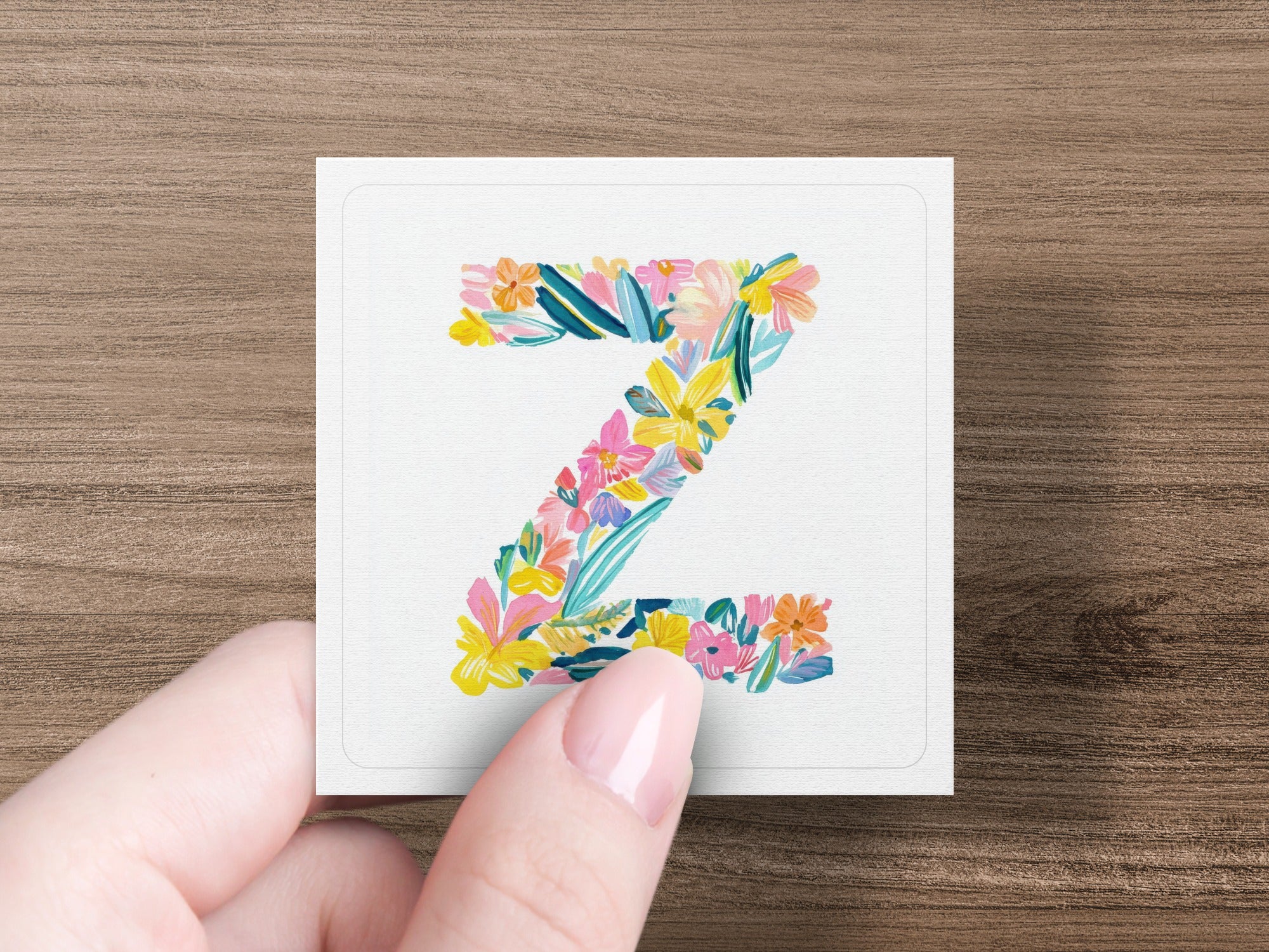 Letter Z decorated with colorful watercolor flowers and leaves.