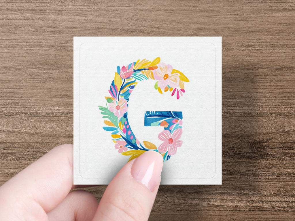 Alphabet letter G decorated with colorful flowers and leaves.