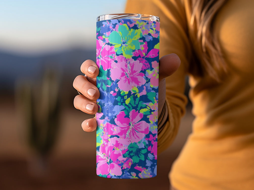 Tumbler with a vibrant pink, blue, and green floral pattern.