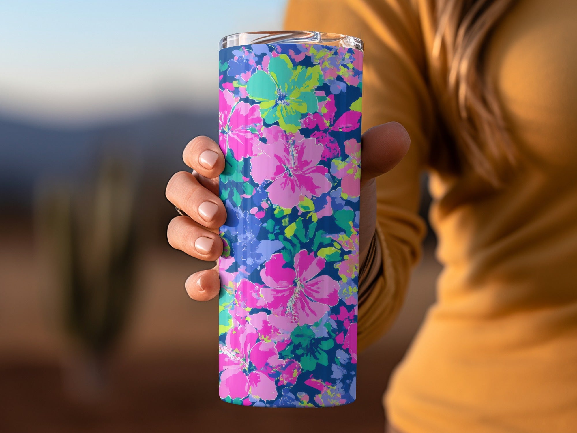 Tumbler with a vibrant pink, blue, and green floral pattern.