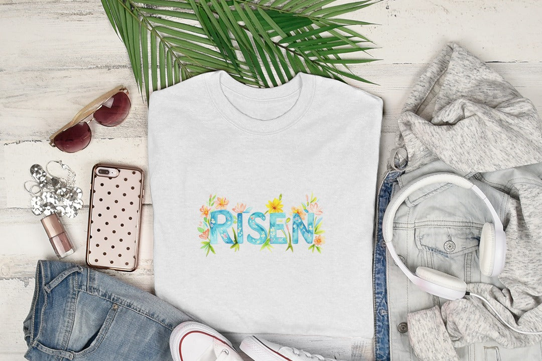White t-shirt with "Risen" in watercolor floral lettering.