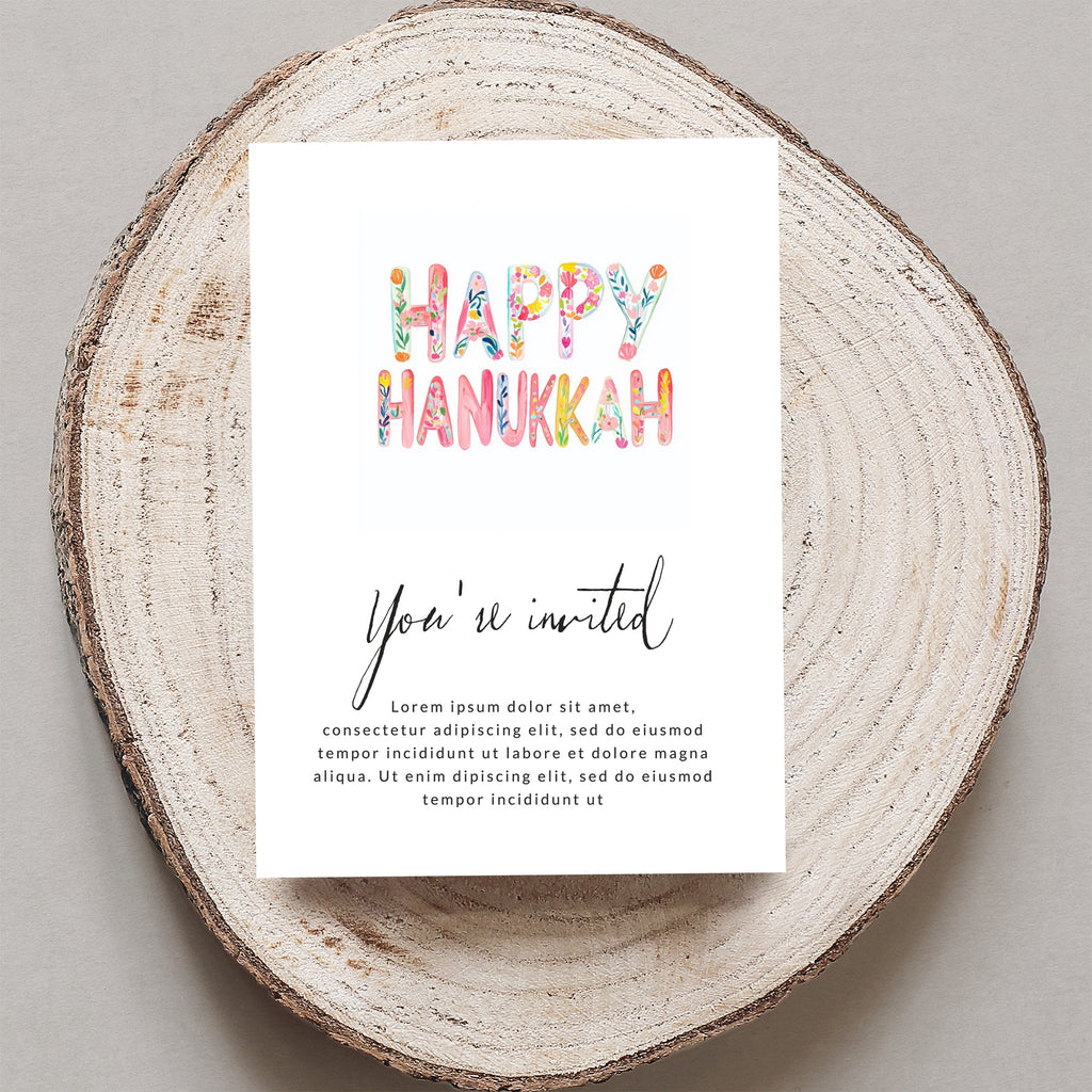 Happy Hanukkah invitation with floral lettering, reads "You're invited"