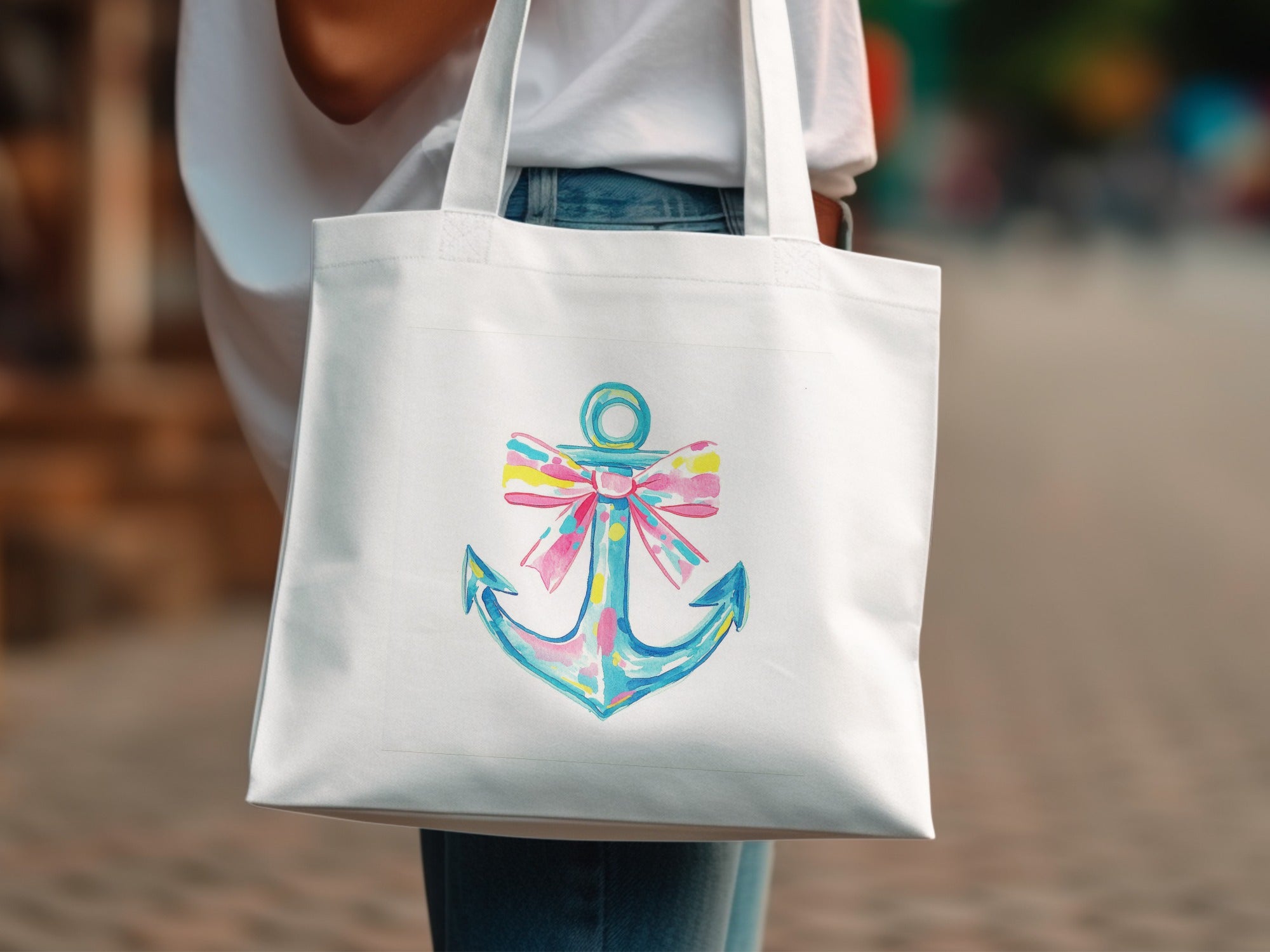 White tote bag with colorful anchor and bow design.