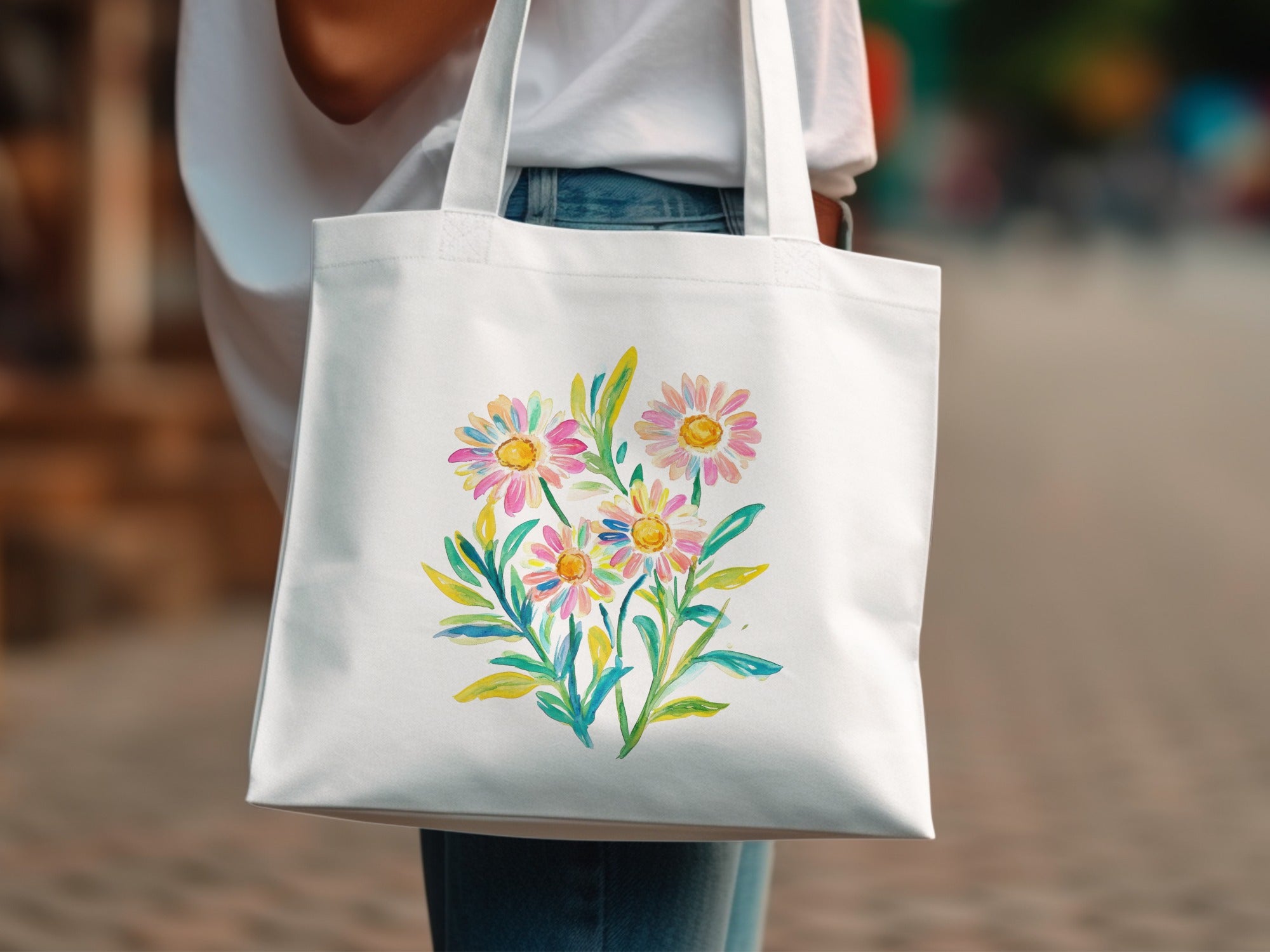 White tote bag with a watercolor floral bouquet featuring daisies and greenery.