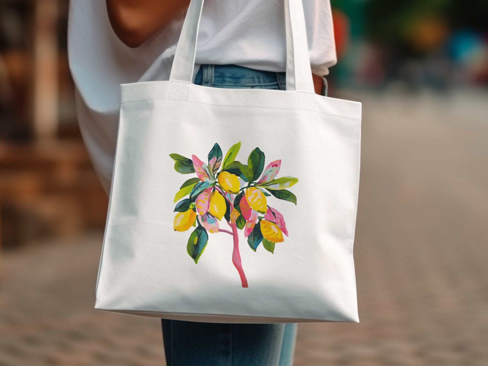 White canvas tote bag featuring a watercolor illustration of a lemon tree branch.