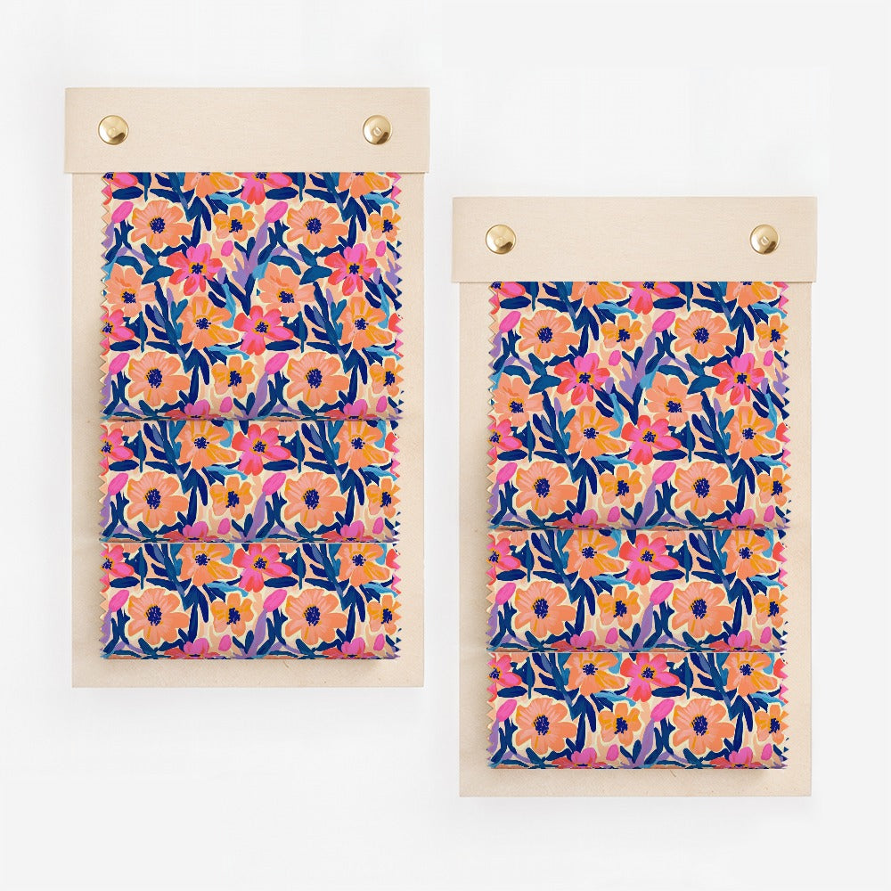 Two fabric swatches with a floral pattern of pink, blue, and orange flowers.