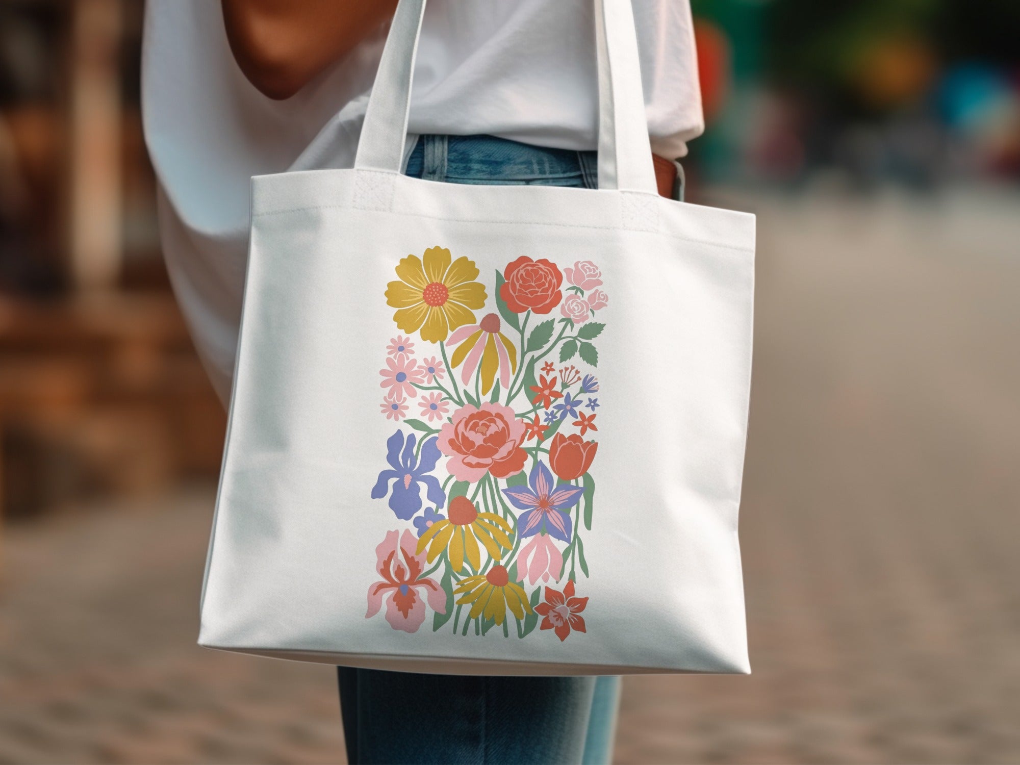 White tote bag with a colorful floral illustration.