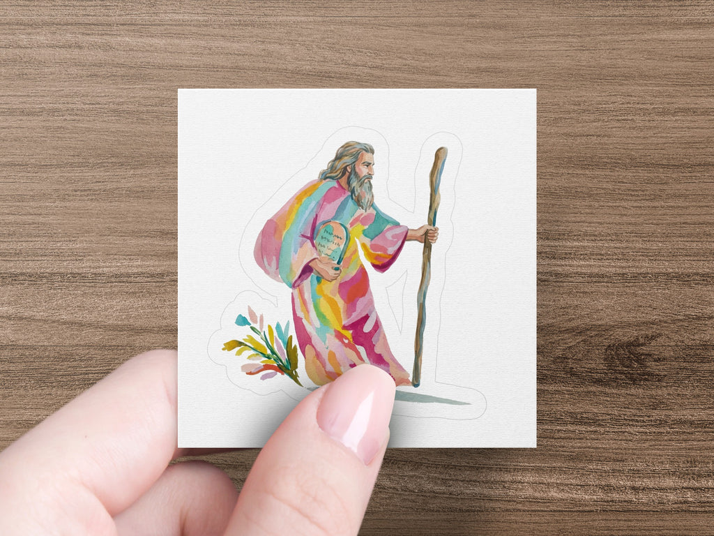 Rainbow-robed figure holding a staff and a colorful orb with text.
