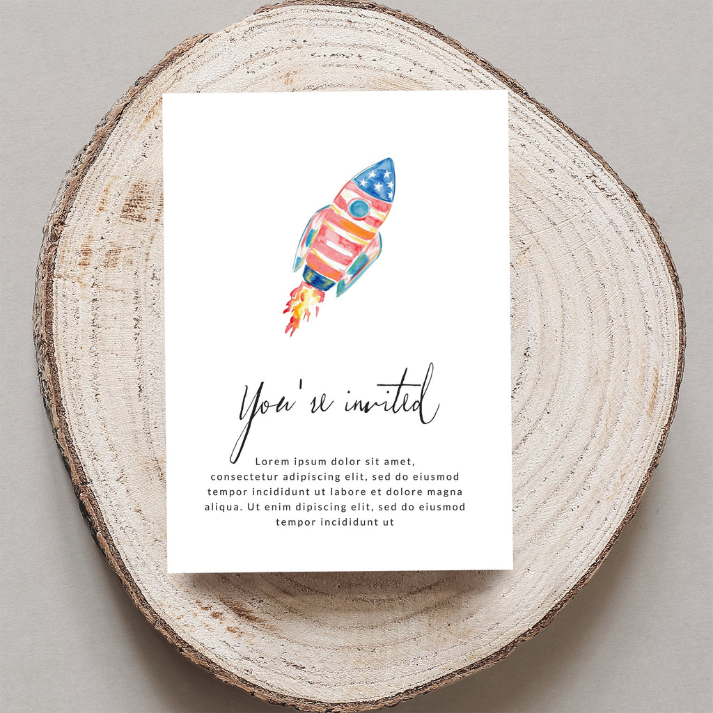 Watercolor rocket invitation on wood slice, reads "You're invited".