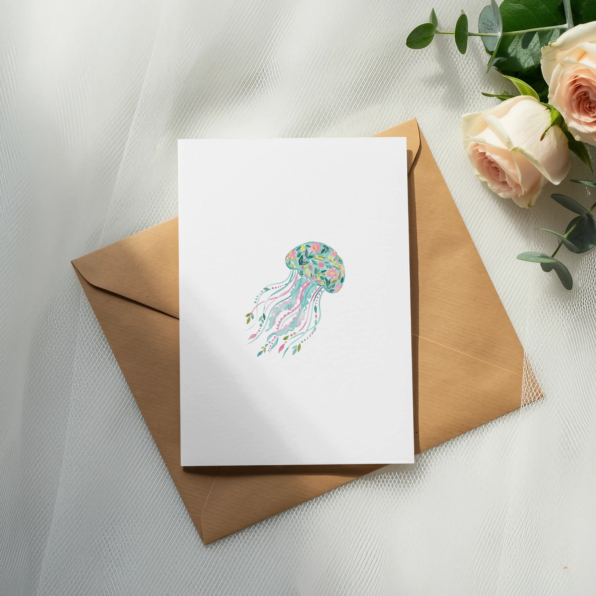 Blank greeting card with colorful jellyfish illustration on kraft envelope.