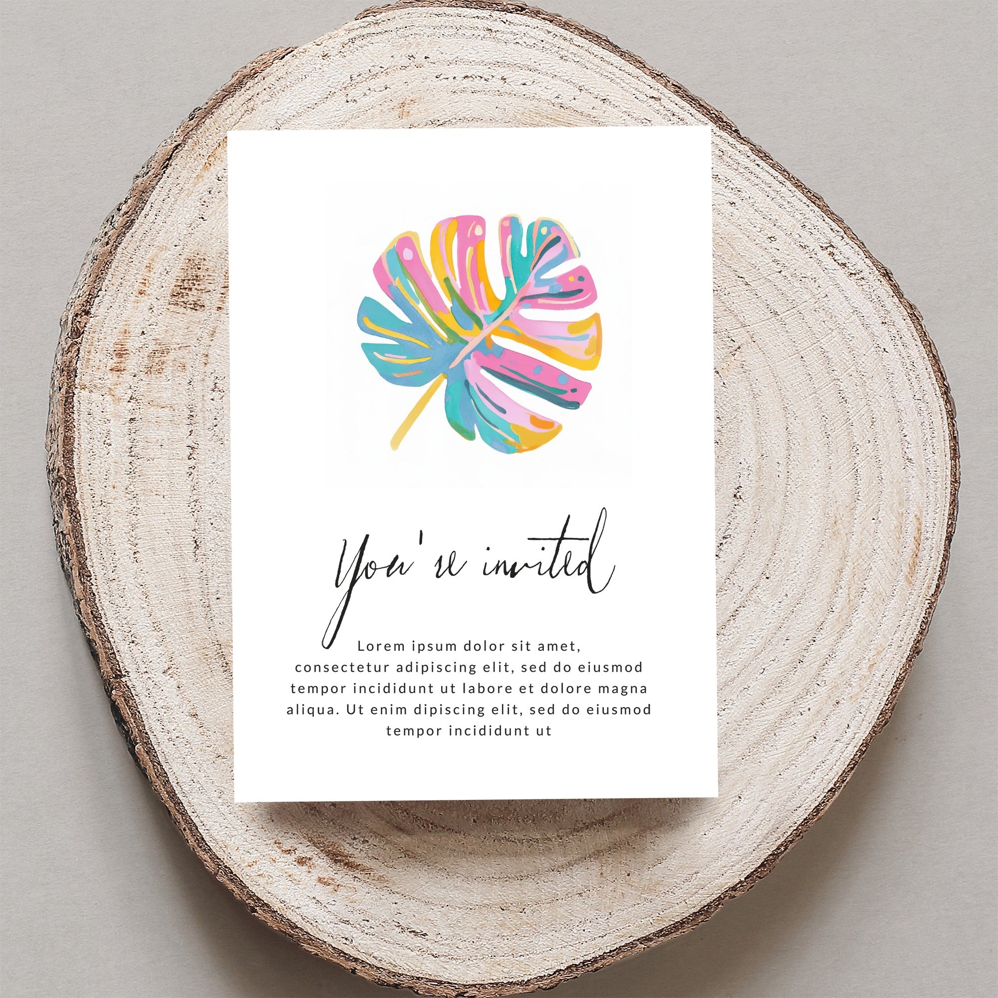 Invitation card with "You're invited" text and a colorful monstera leaf.