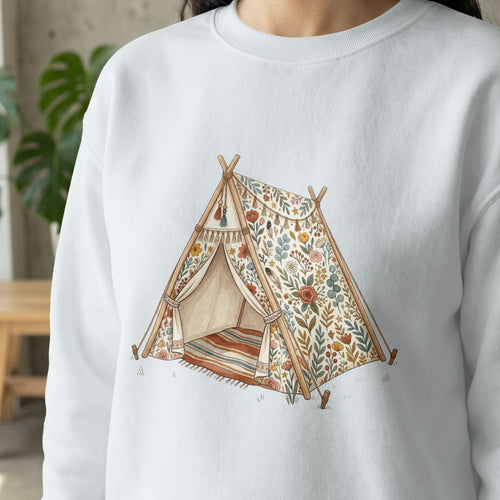 White sweatshirt with a watercolor teepee design featuring floral patterns and a striped rug.