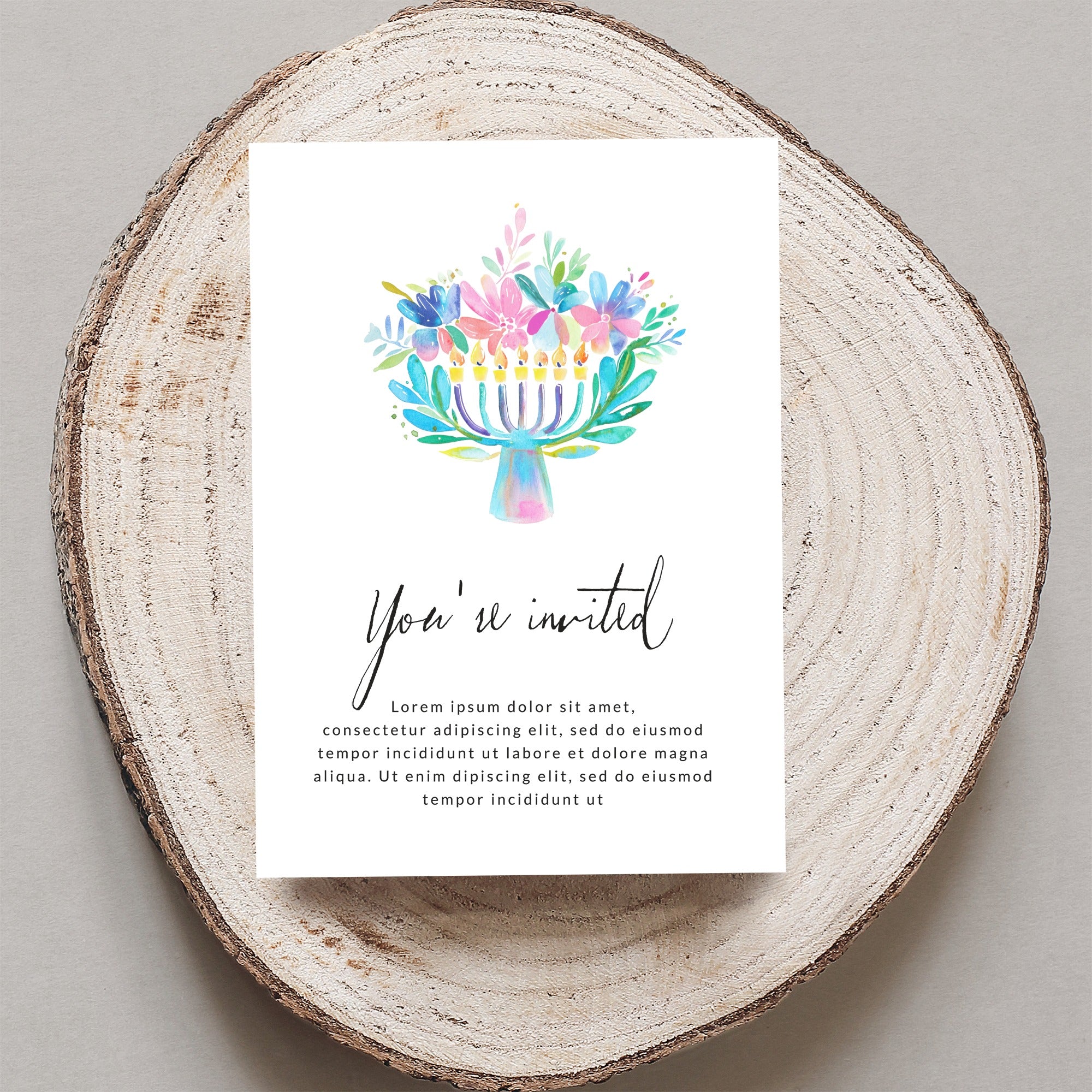Watercolor menorah with "You're invited" text on rustic wood.