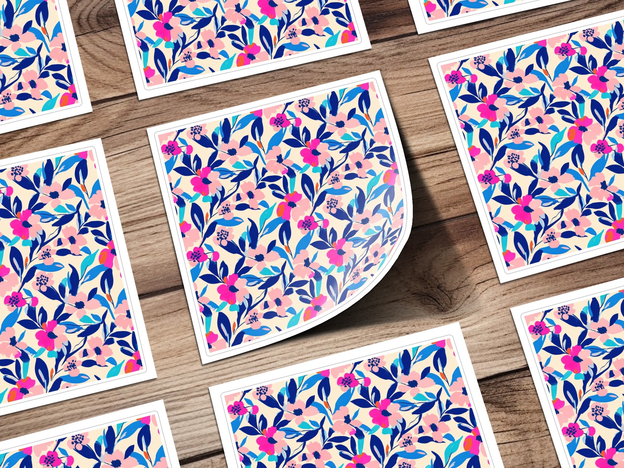 Floral pattern with blue, pink, and white flowers on a wooden background.