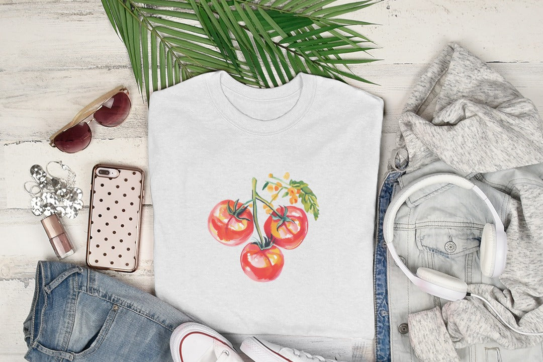 White t-shirt featuring a watercolor illustration of three ripe tomatoes on a vine.
