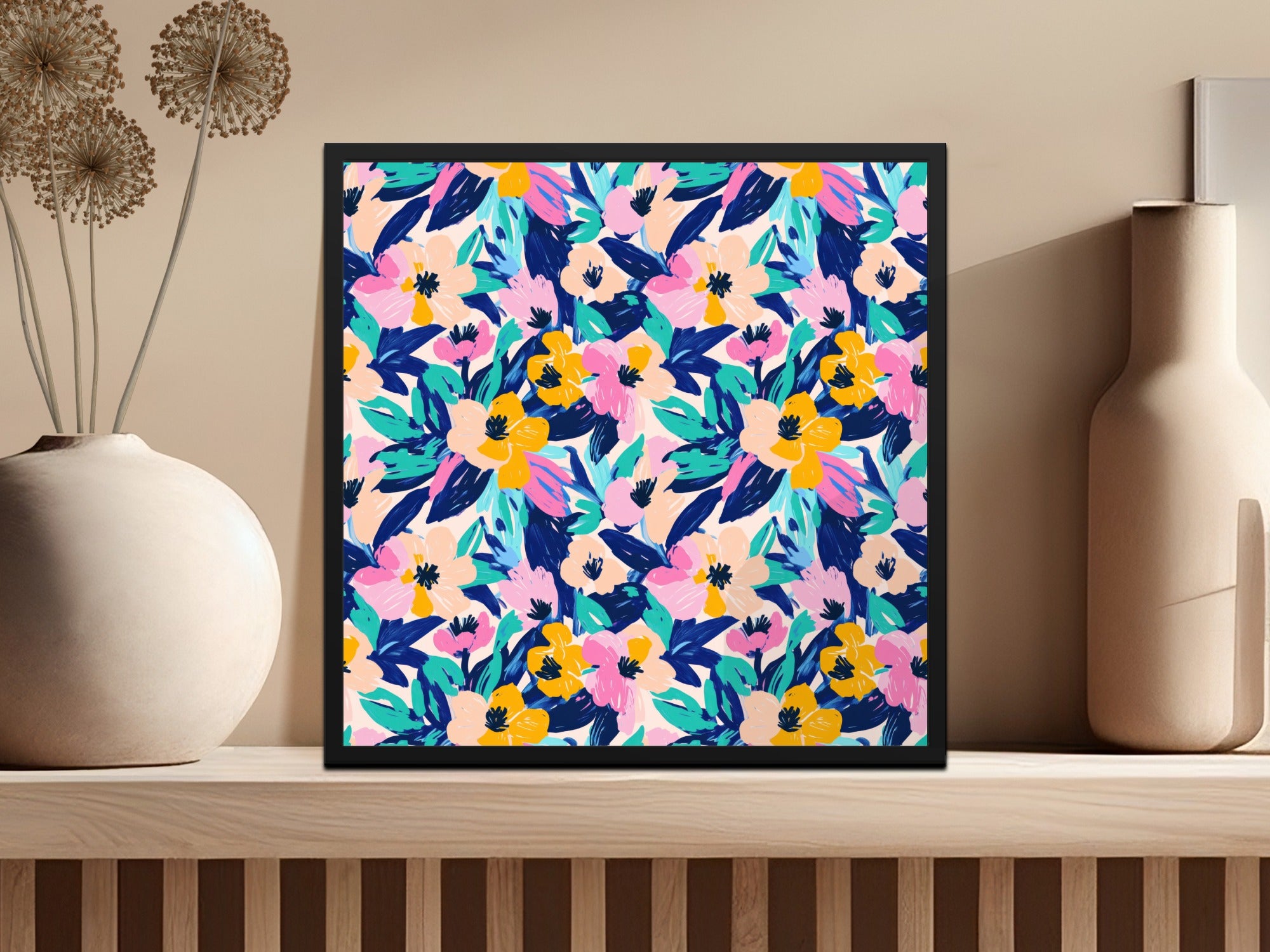 Framed artwork with a vibrant floral pattern on a shelf.