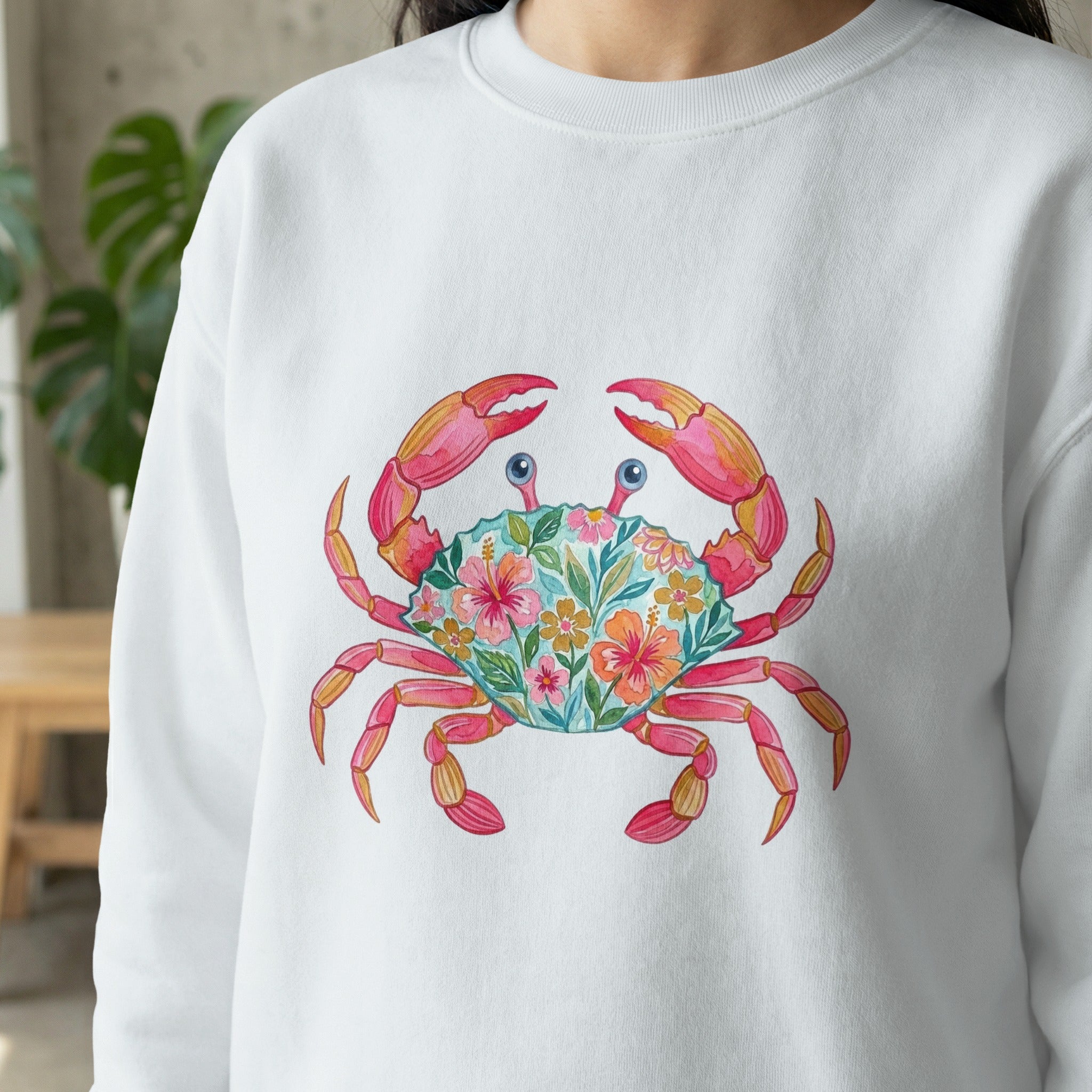 White sweatshirt with a floral crab graphic on the chest.