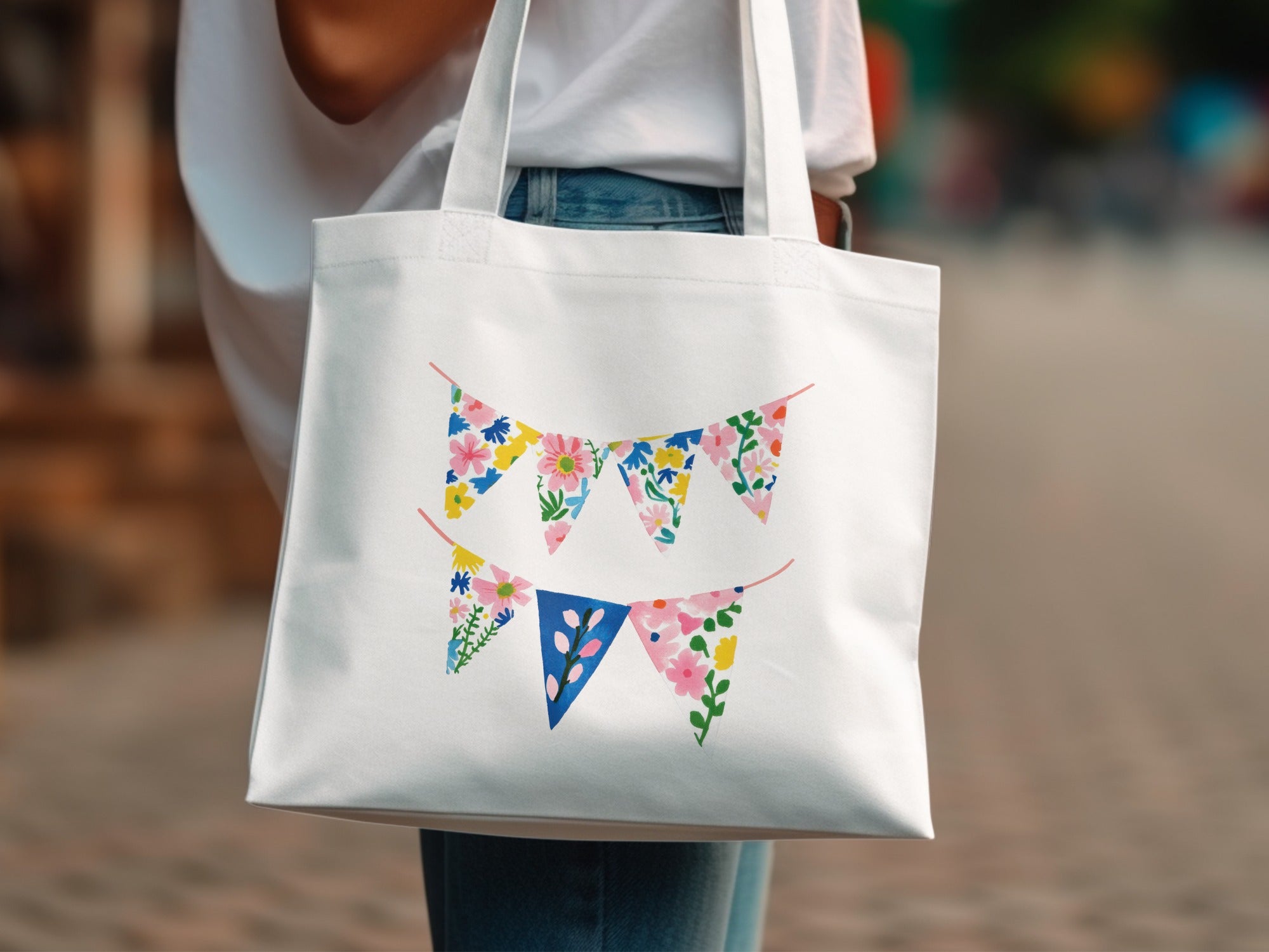 White tote bag with floral and pennant banner designs.
