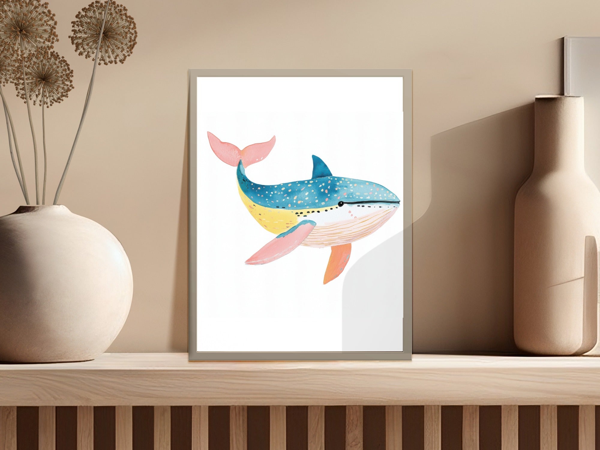 Watercolor painting of a blue and orange whale on a shelf.