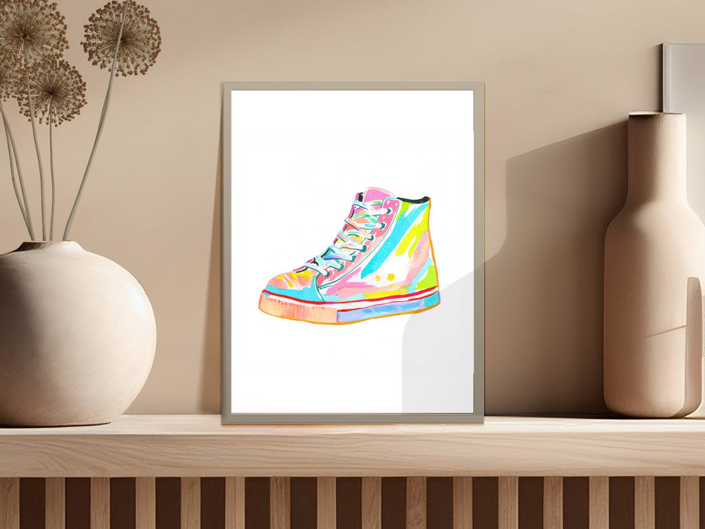 Colorful high-top sneaker illustration in a framed picture on a shelf.