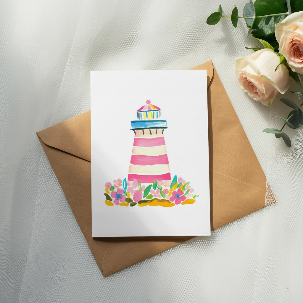 Watercolor lighthouse with flowers on a card atop a brown envelope.