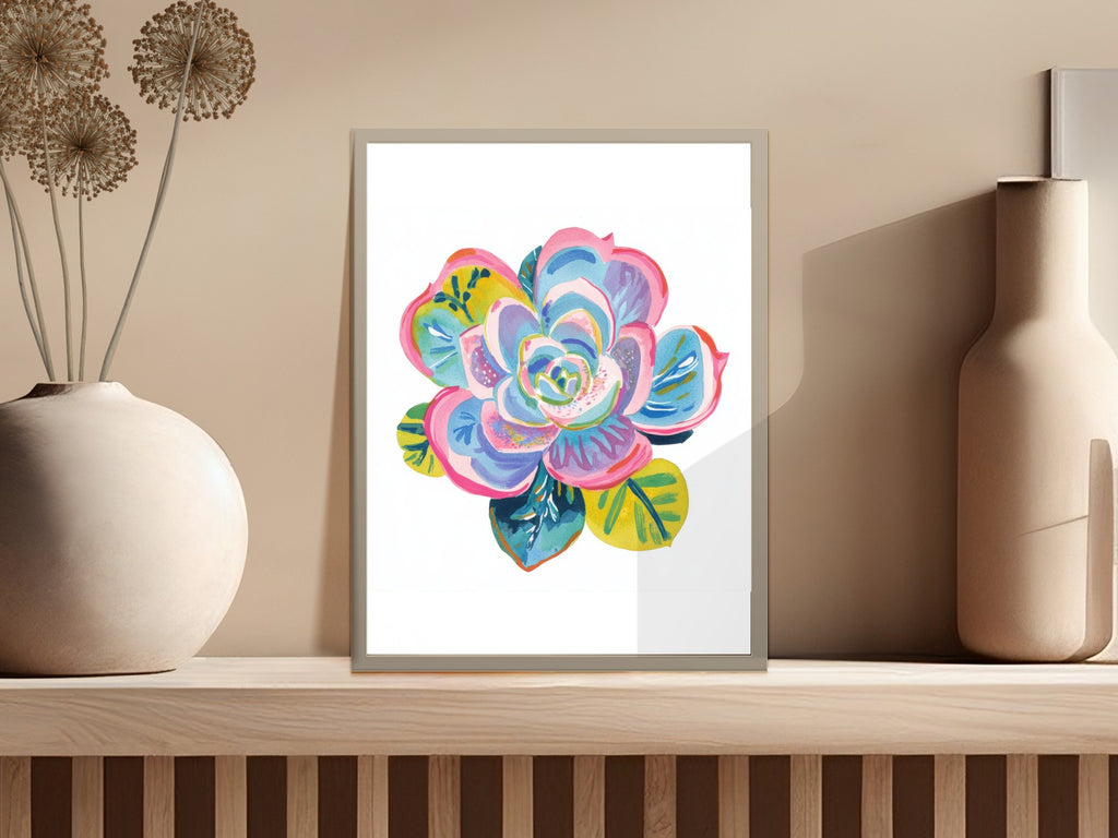 Colorful succulent painting in a silver frame on a shelf.