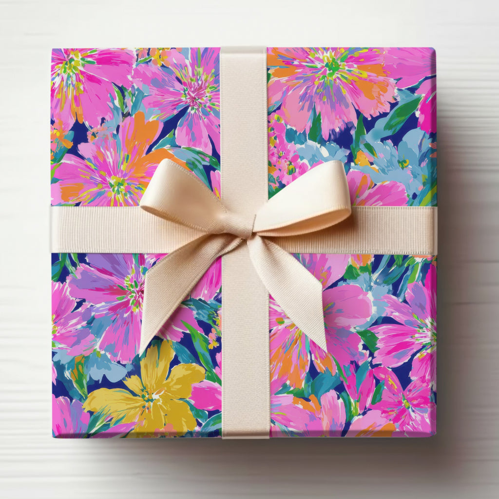 Gift box wrapped in floral paper with a light beige ribbon bow.