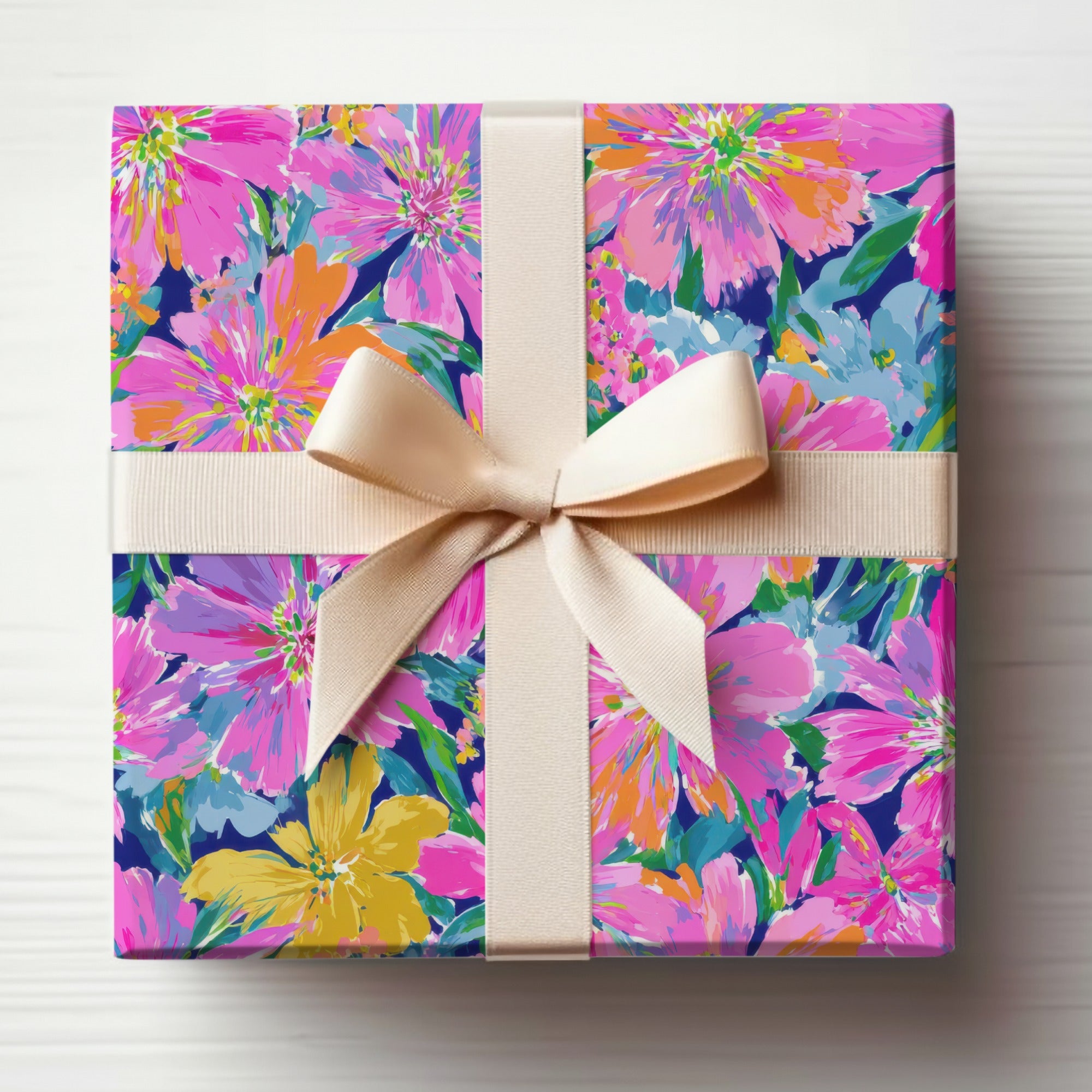 Gift box wrapped in floral paper with a light beige ribbon bow.