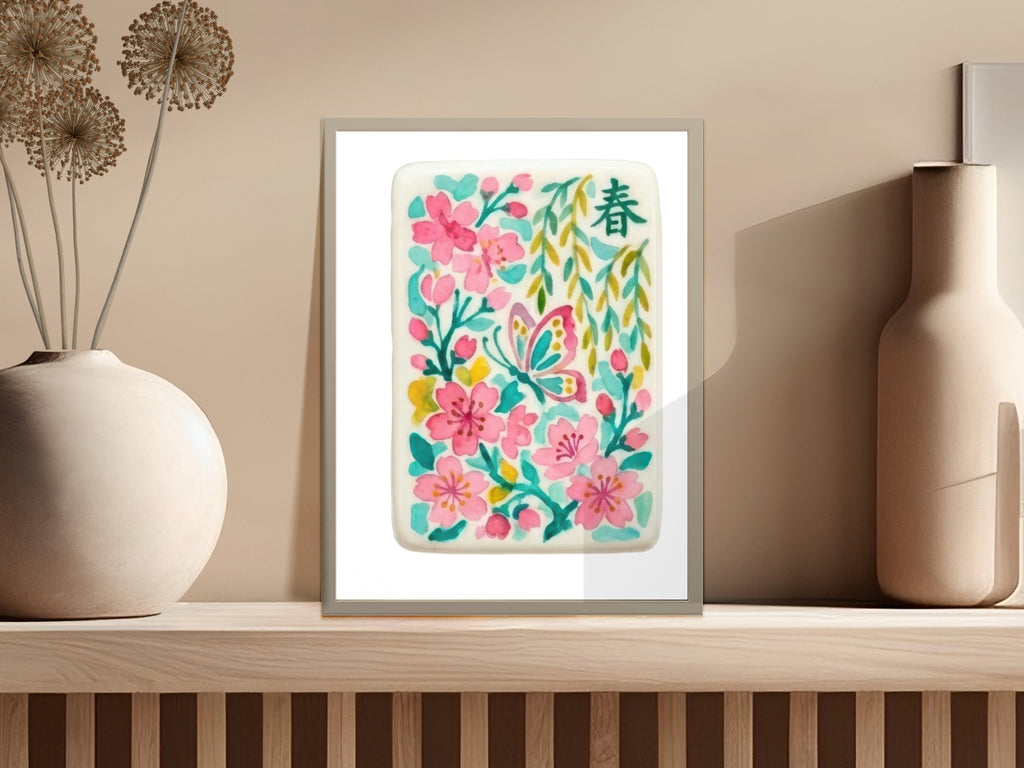 Framed artwork of pink flowers and a green butterfly with a Chinese character.