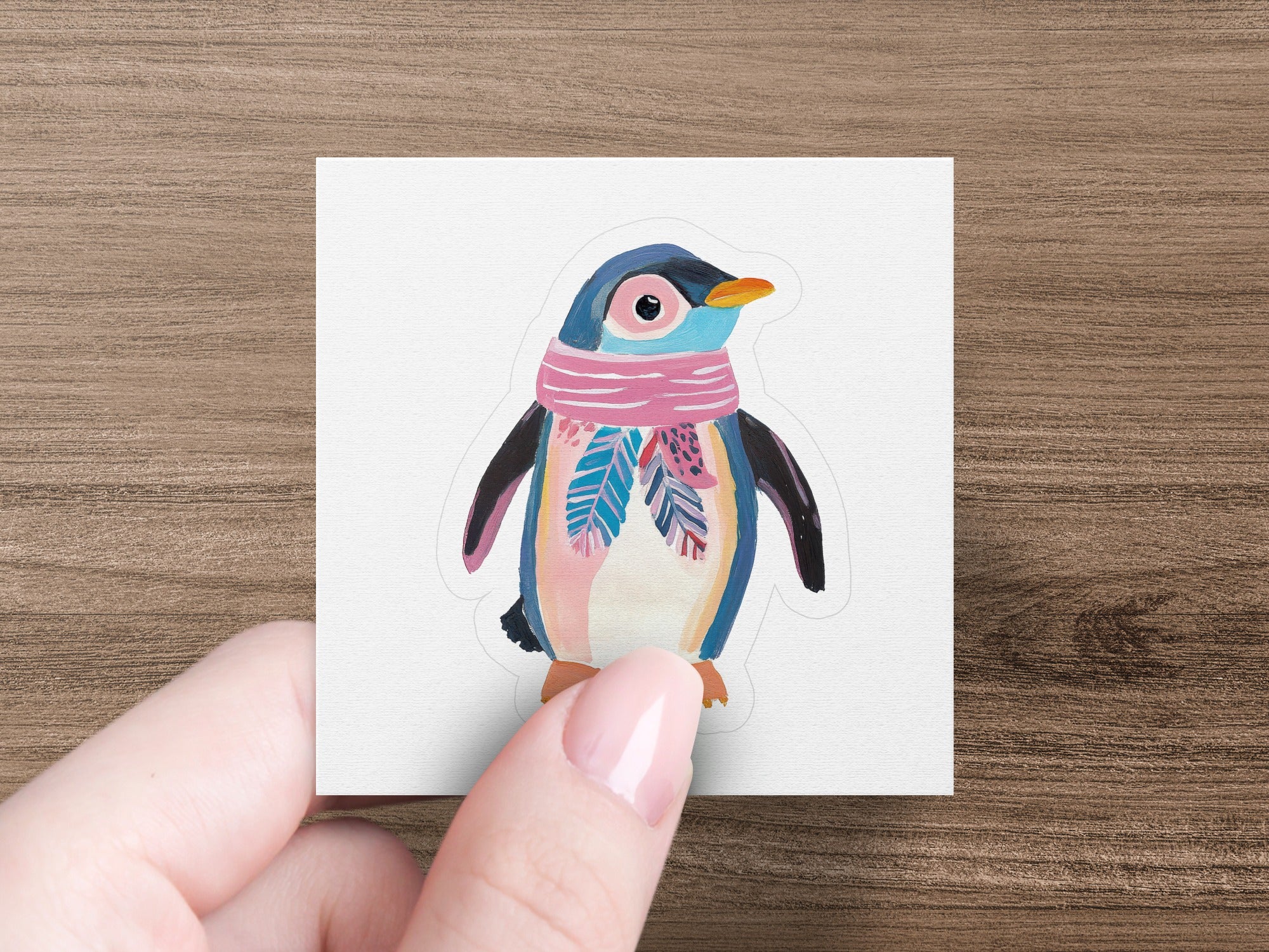 Cartoon penguin wearing a pink and blue striped scarf.