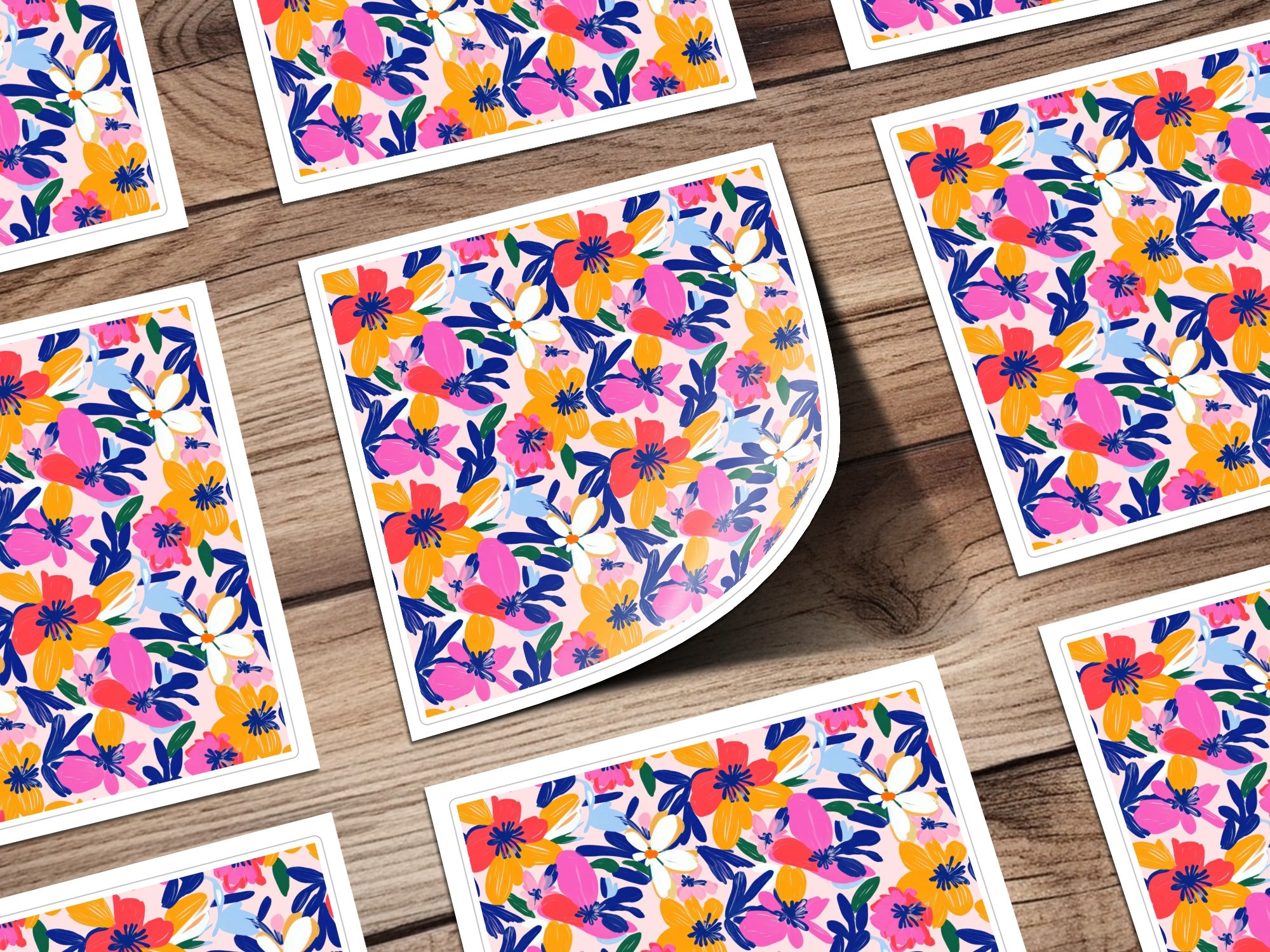 Floral stickers with pink, blue, and orange flowers on wood.