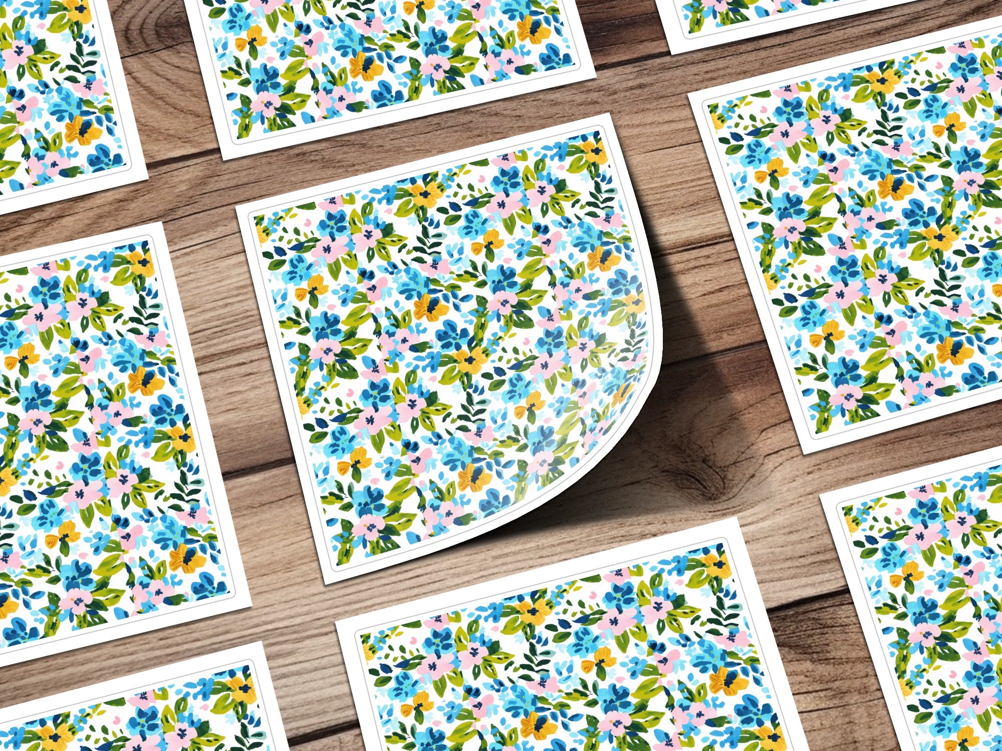 Floral pattern on square cards with a wooden background.