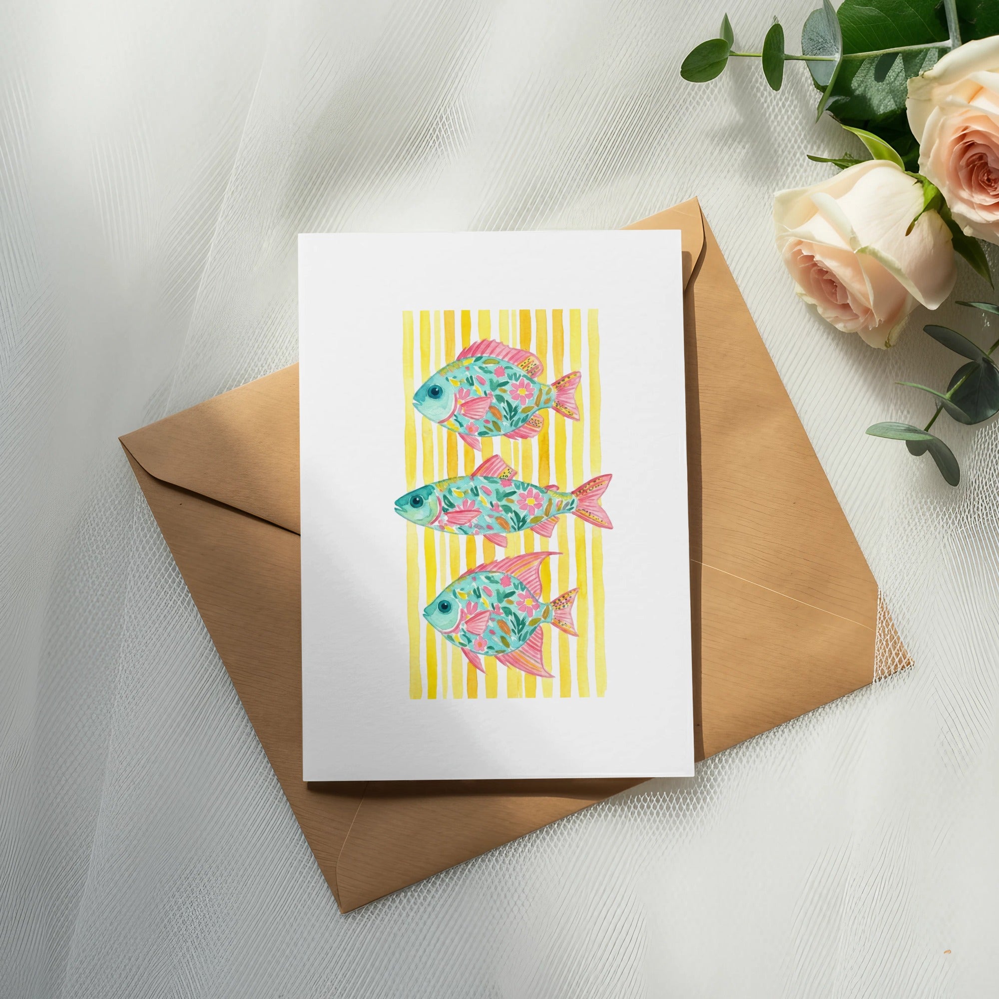 Card with three stylized pink and turquoise fish on a yellow striped background.