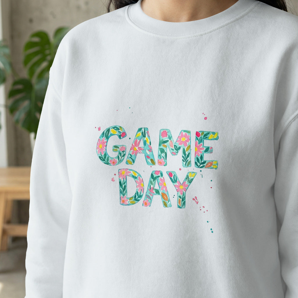 White sweatshirt with "GAME DAY" in floral watercolor lettering.