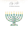 Floral menorah with nine lit candles on a white background.