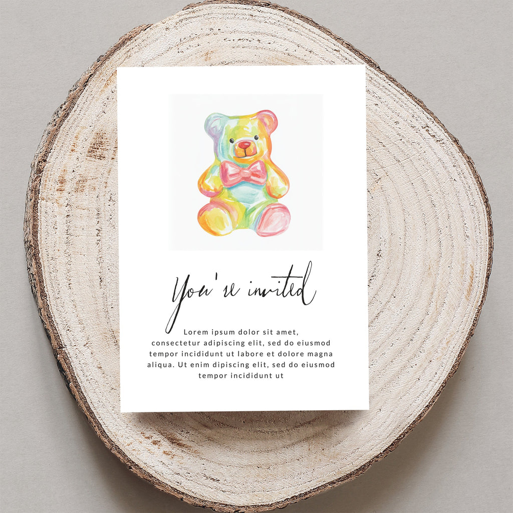 Invitation with a rainbow teddy bear and "You're invited" text.
