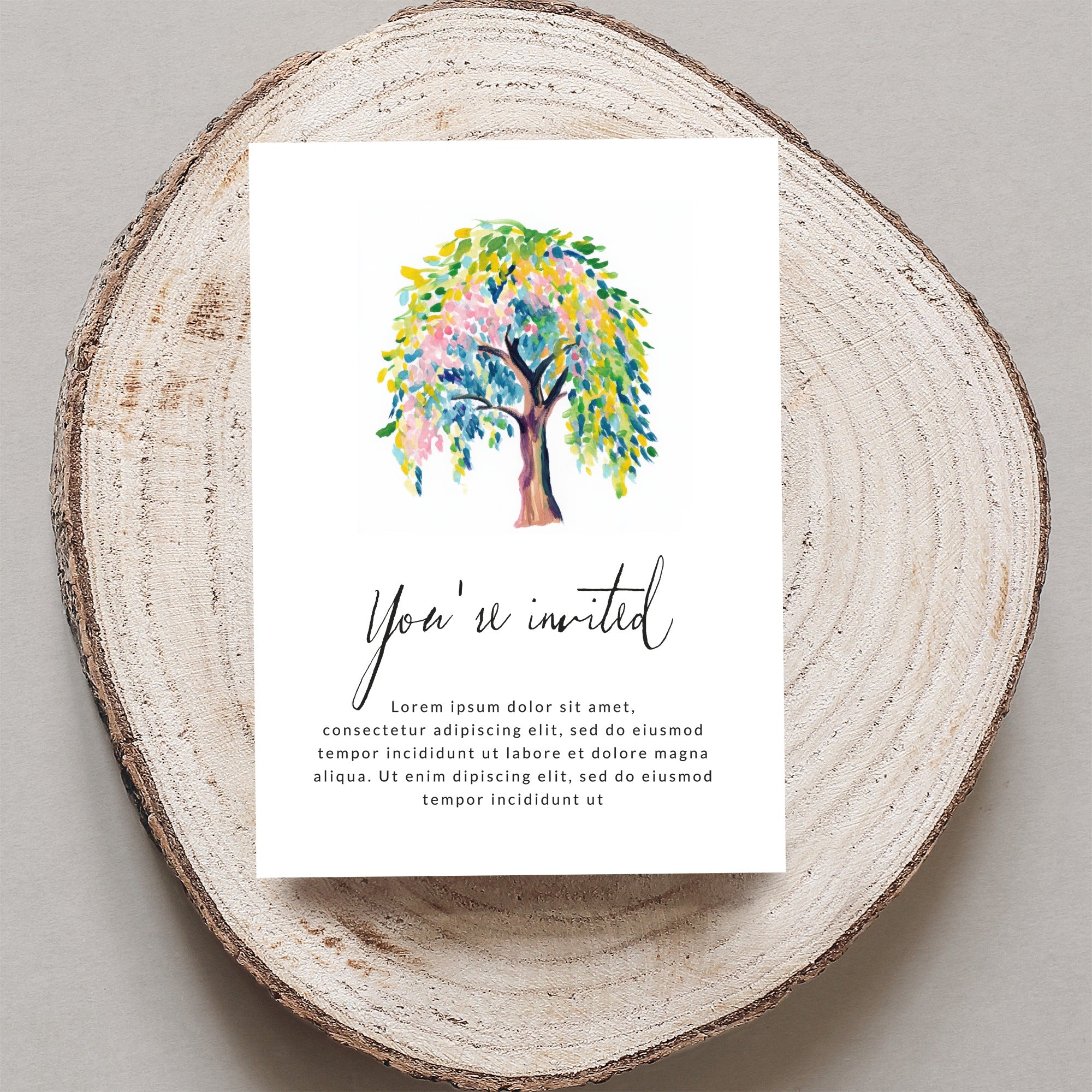 Invitation with colorful tree and "You're invited" text.